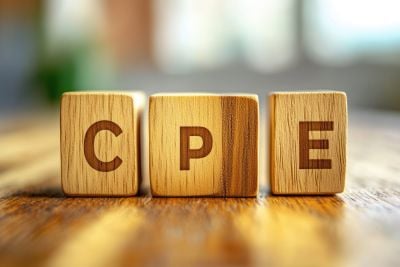Wooden blocks spelling “CPE” on a tabletop, representing continuing professional education.