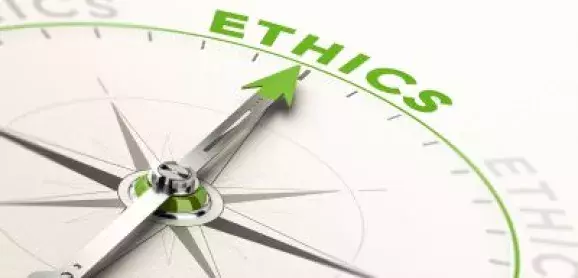 Compass with a green needle pointing toward the word “Ethics,” symbolizing ethical guidance and professional responsibility.